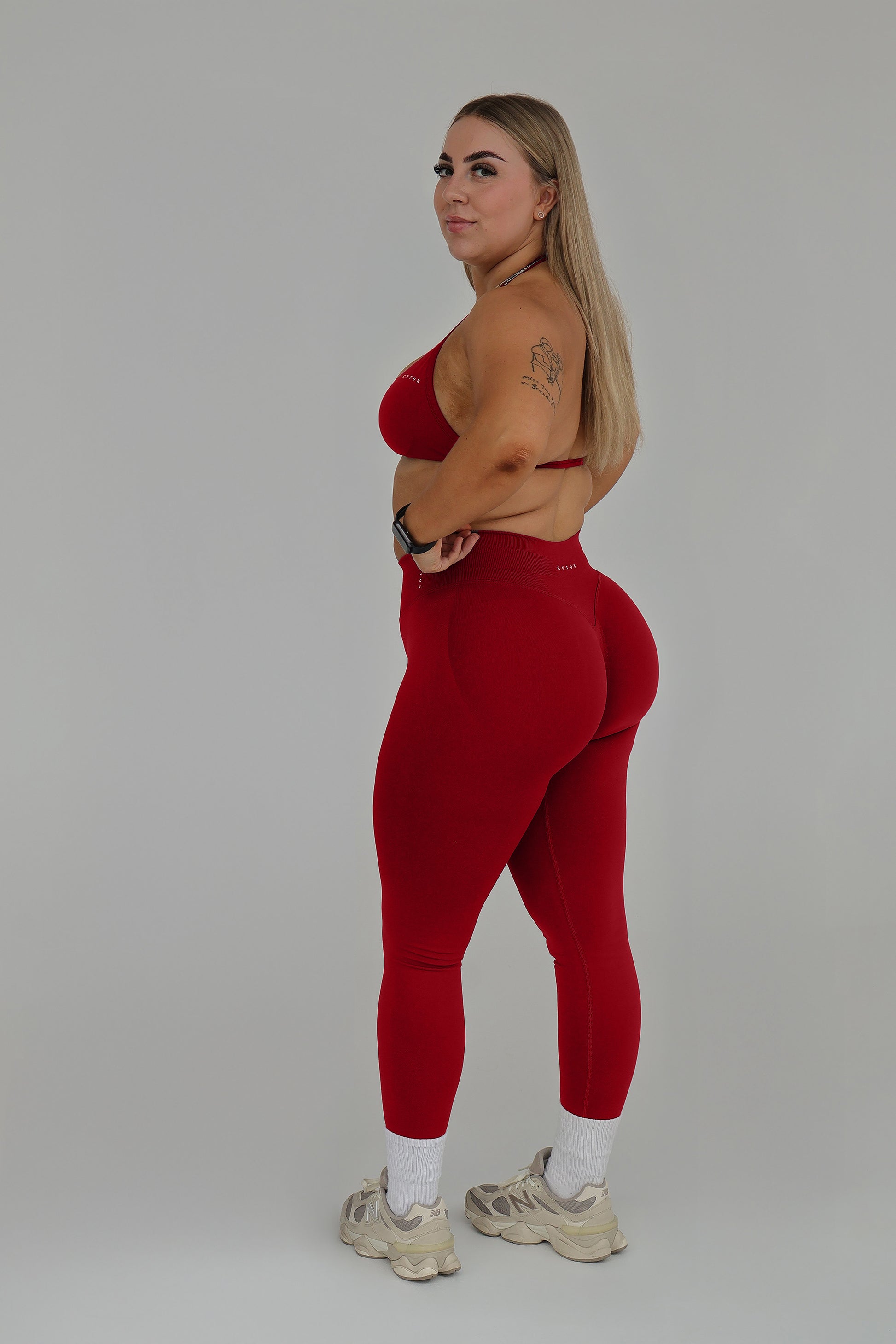Model wearing the Cherry seamless activewear set from CNTOR the Label, featuring bold red tones and sculpting seamless design.