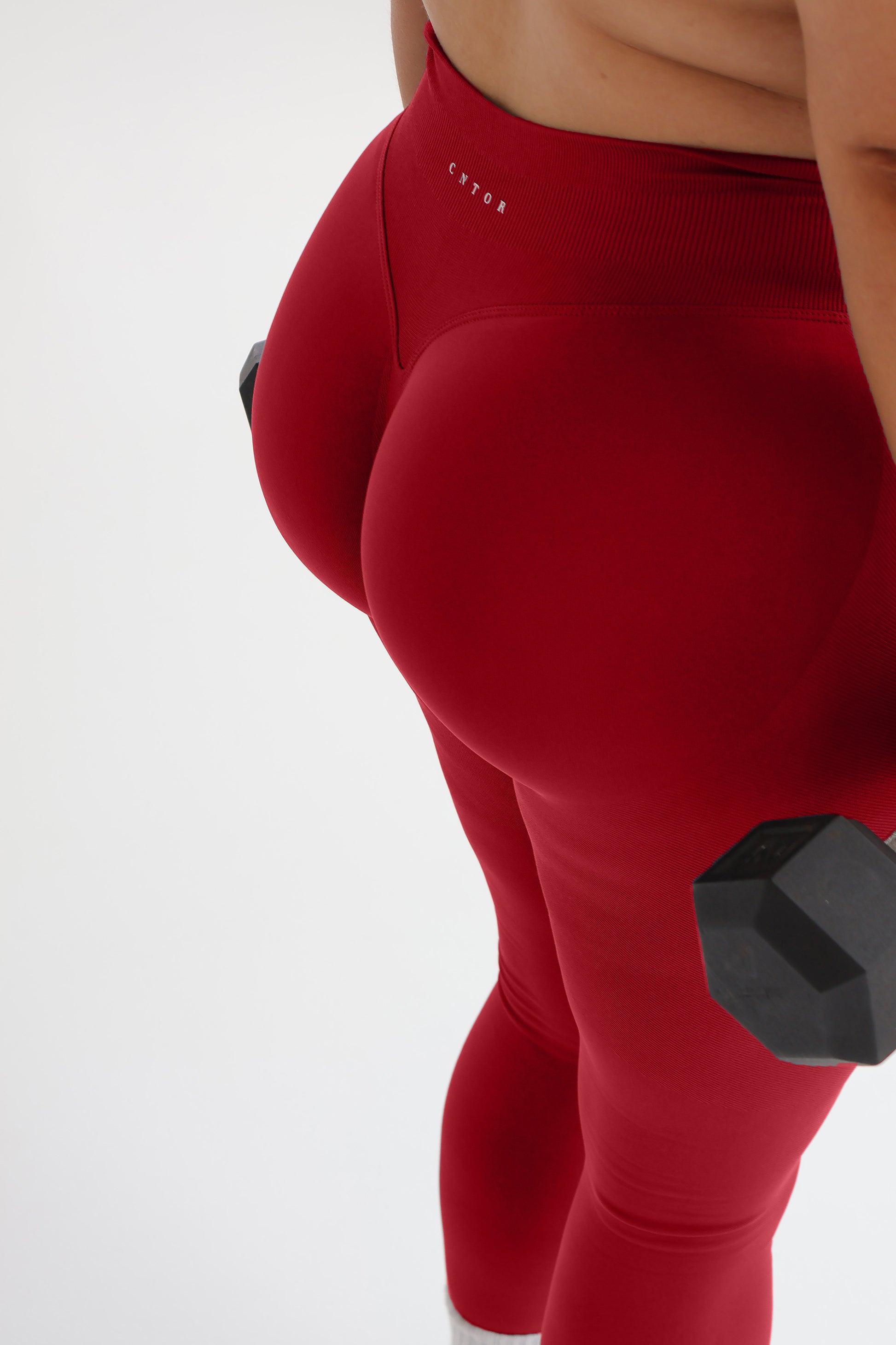 Model wearing the Cherry seamless activewear set from CNTOR the Label, featuring bold red tones and sculpting seamless design.