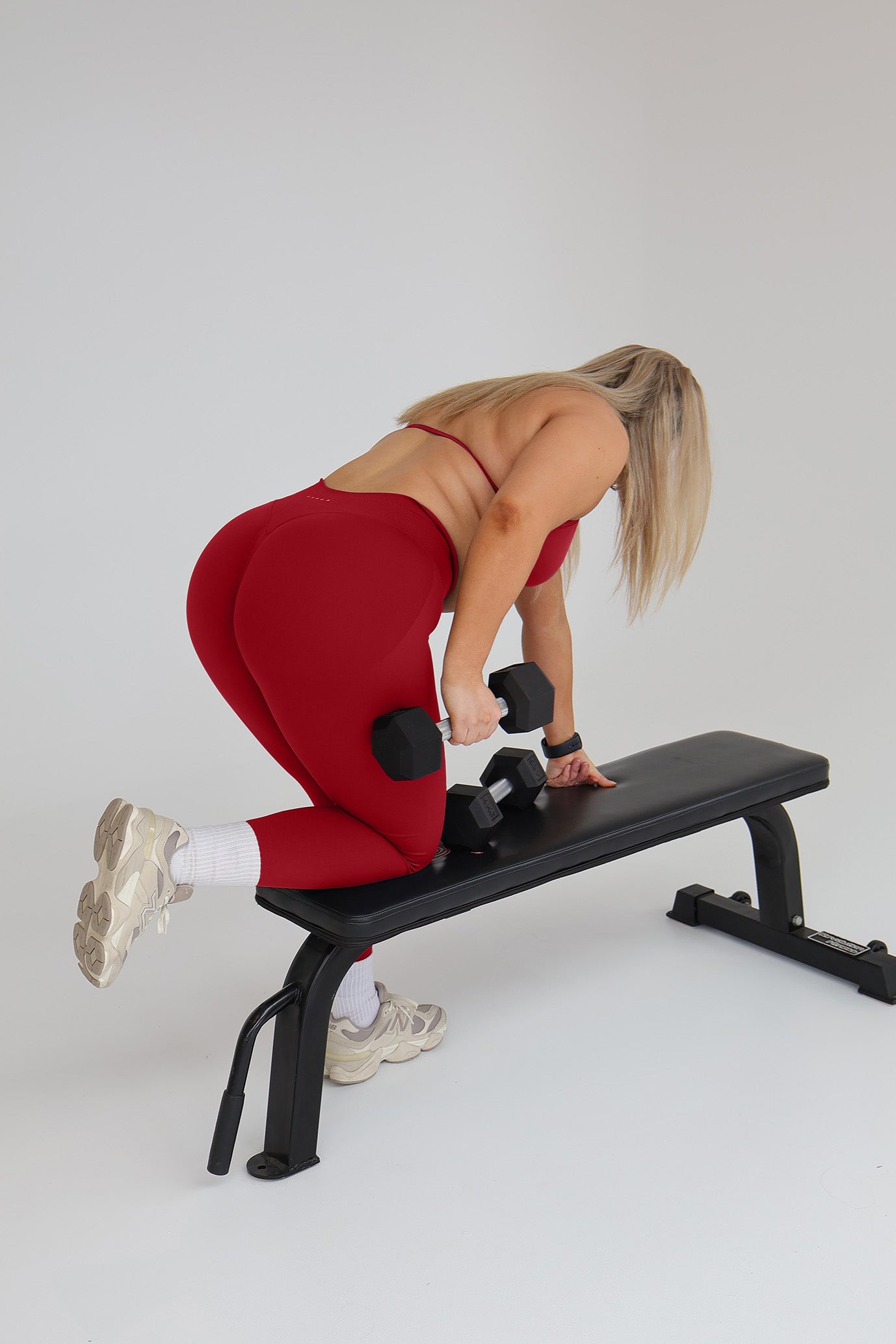 Model wearing the Cherry seamless activewear set from CNTOR the Label, featuring bold red tones and sculpting seamless design.