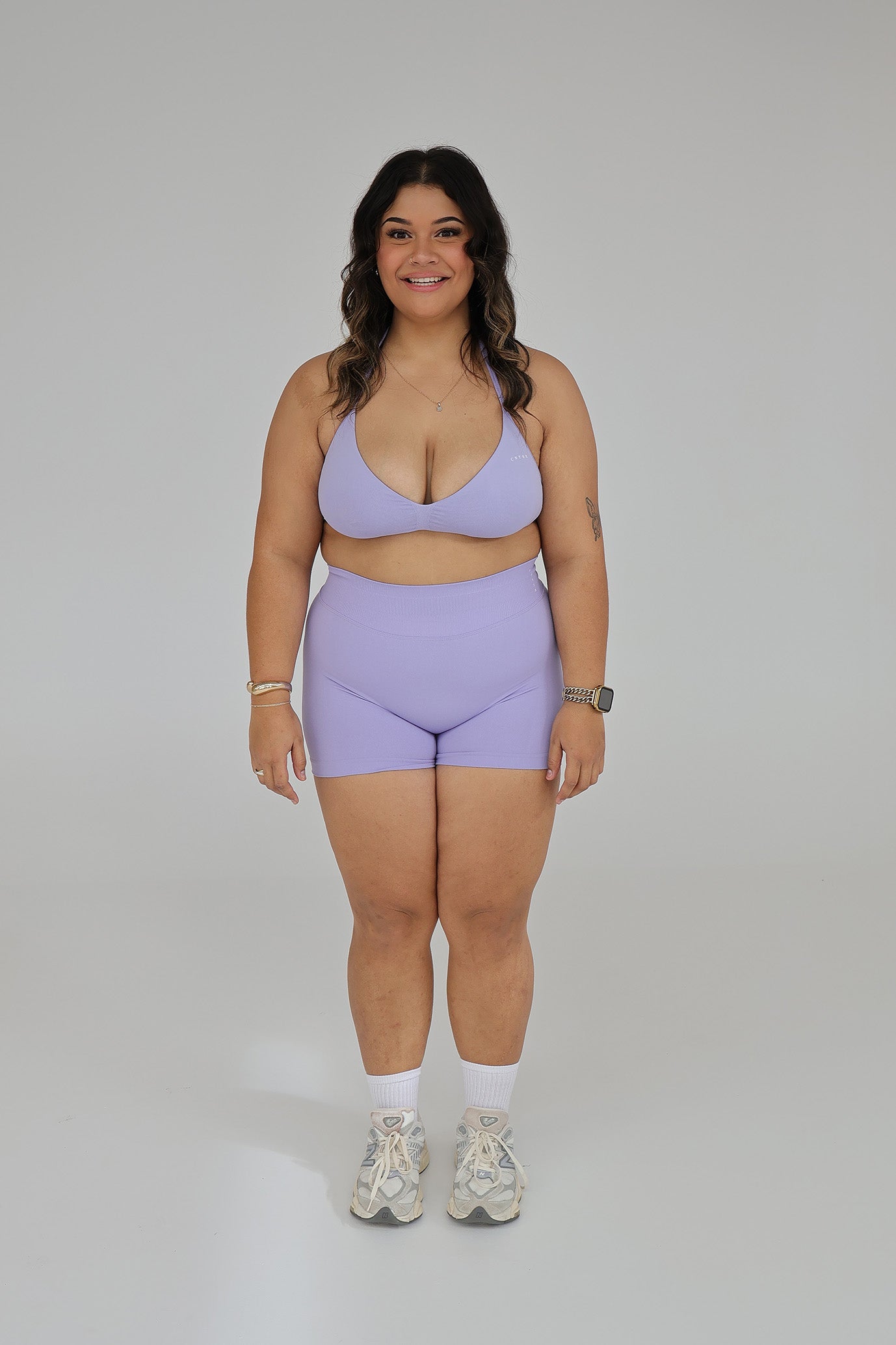 Model wearing the Lilac seamless activewear set from CNTOR the Label, featuring soft purple tones and sculpting seamless design.